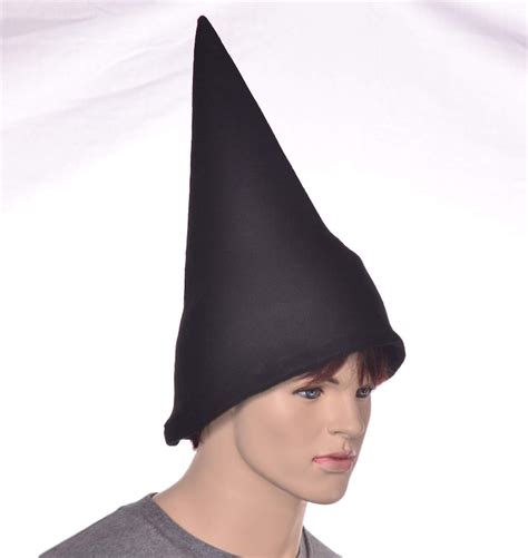 What does a black pointed hat symbolize in witchcraft